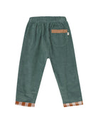 A pair of children's corduroy pants in a muted sage green color, featuring an elastic waistband, a back pocket with a tan leather accent, and orange-and-white gingham trim at the turned-up cuffs.