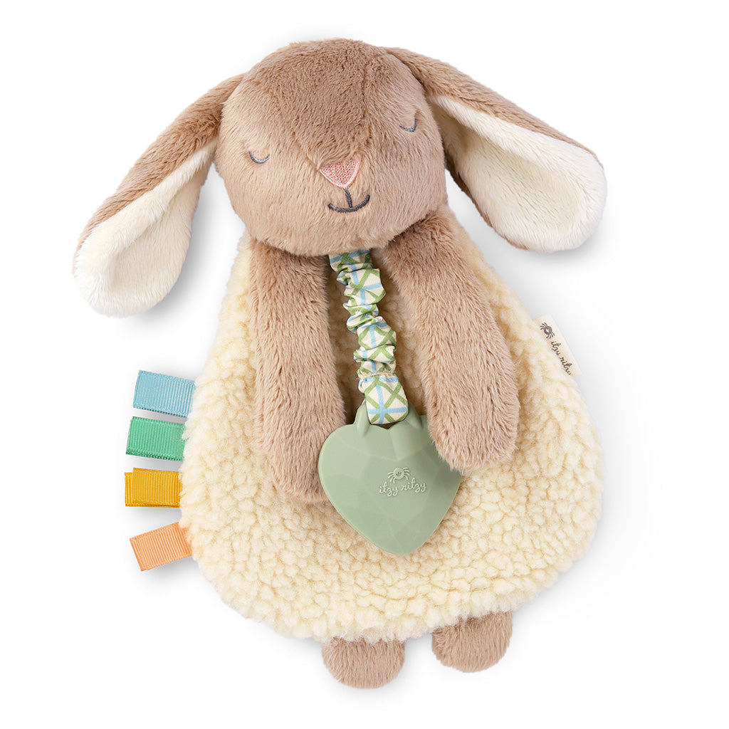Plush bunny toy with a teething ring and colorful elements on a white background