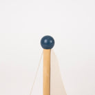 A close-up of top of wooden sailboat, set against a plain white background