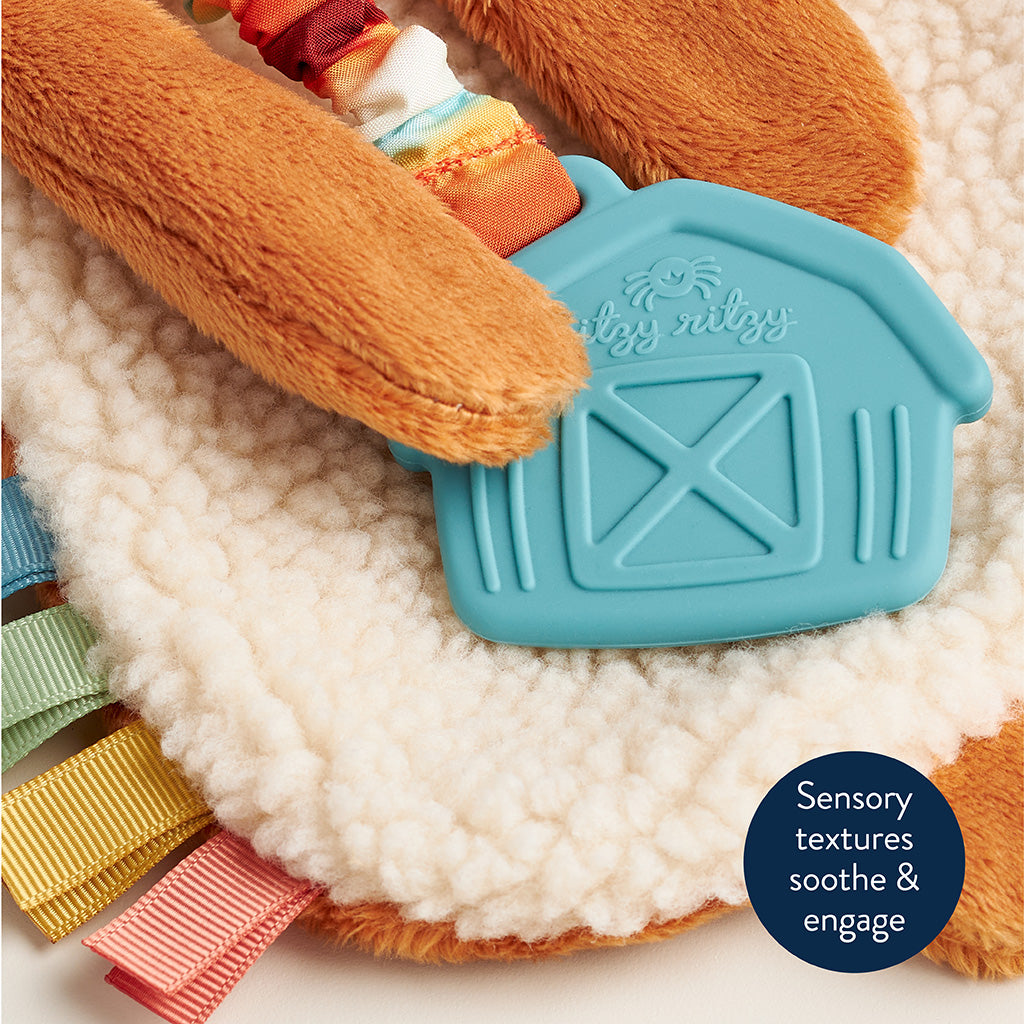 Toy with sensory textures and a barn design on a soft surface