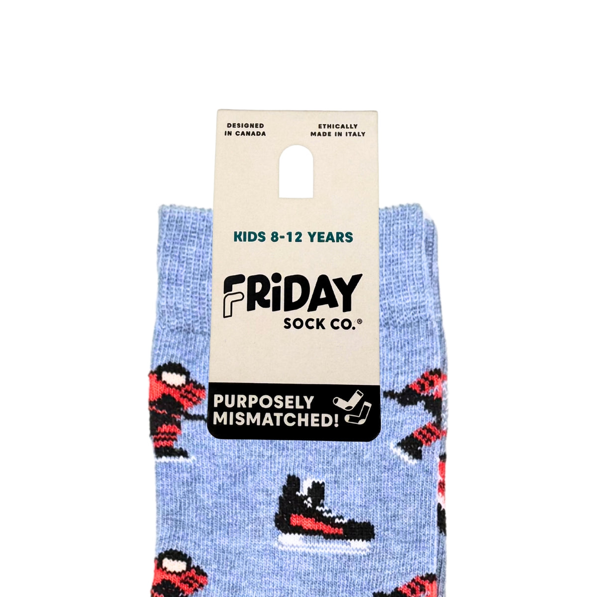 A pair of light blue patterned socks with red, black, and white shoe motifs, hanging from a beige cardboard hanger that reads 'FRIDAY SOCK CO.' and 'KIDS 8-12 YEARS'.