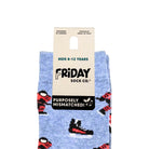 A pair of light blue patterned socks with red, black, and white shoe motifs, hanging from a beige cardboard hanger that reads 'FRIDAY SOCK CO.' and 'KIDS 8-12 YEARS'.