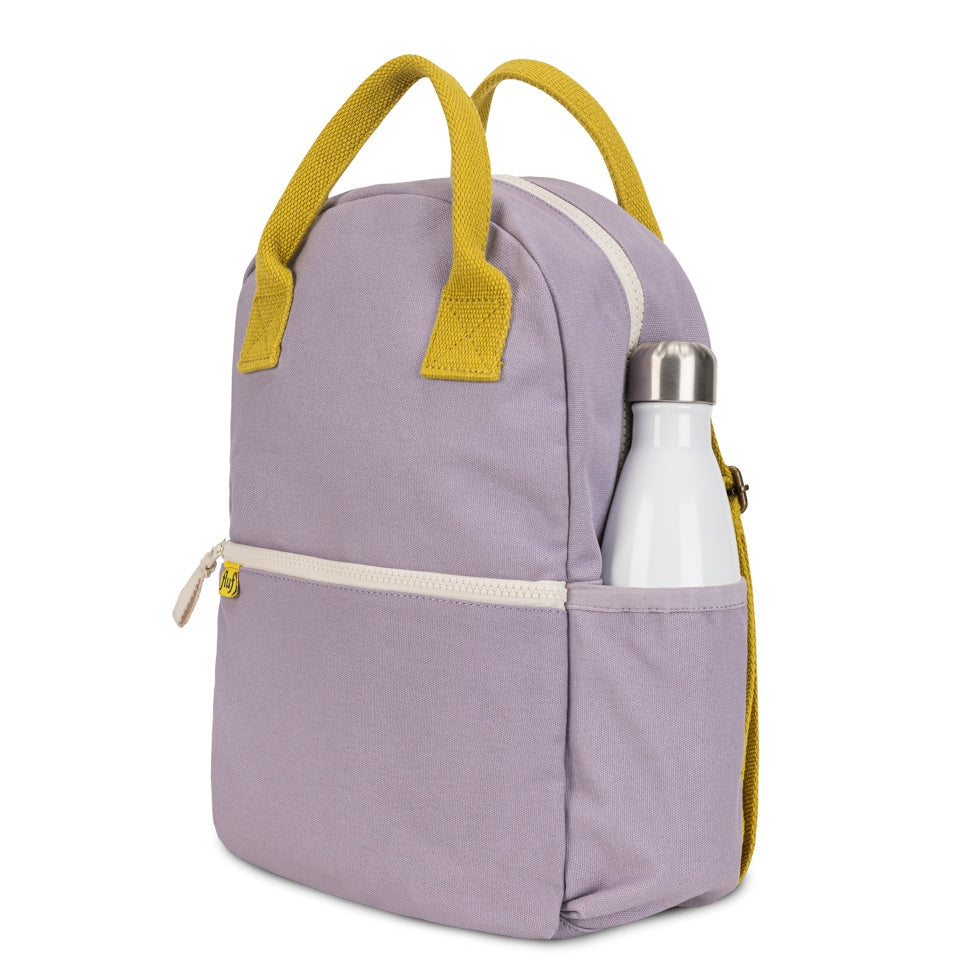 A light purple insulated lunch bag with mustard yellow handles and zipper trim, shown on a white background with a white bottle in its side pocket.