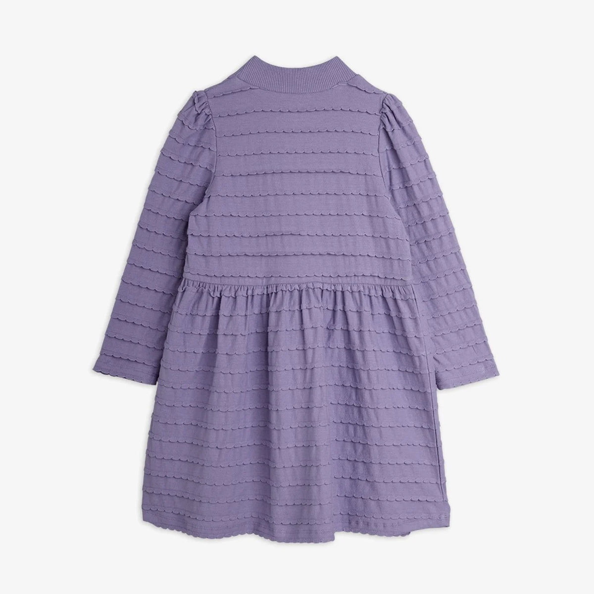 A lavender purple textured dress with long sleeves, a mock neck, and a tiered waist, shown from the back against a light gray background.
