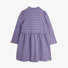 A lavender purple textured dress with long sleeves, a mock neck, and a tiered waist, shown from the back against a light gray background.