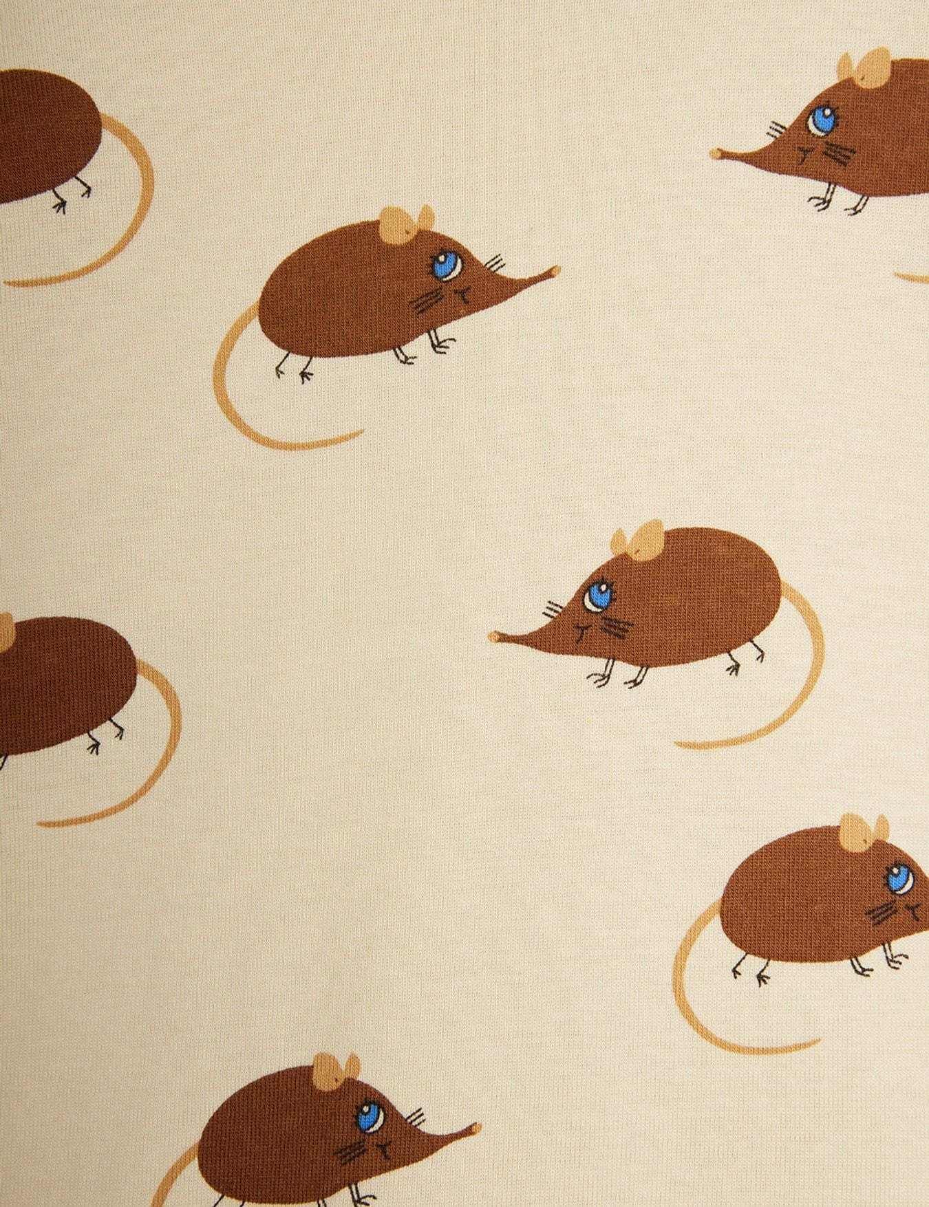 A close-up of a fabric pattern featuring cartoon brown mice with blue eyes and tan tails on a warm cream background.