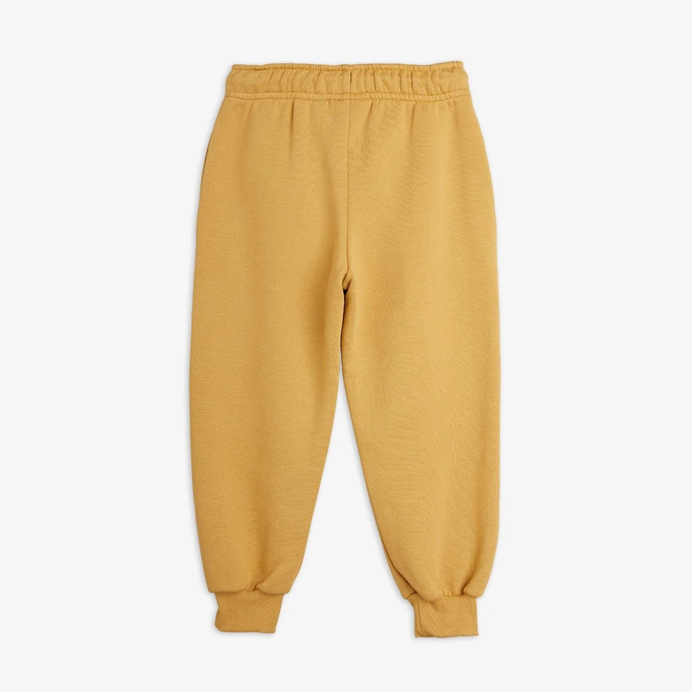 A pair of mustard yellow sweatpants with an elastic waistband and ribbed ankle cuffs, shown flat against a light gray background.