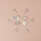 Collection of decorative hair clips on a beige background