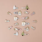 Collection of decorative hair clips on a beige background