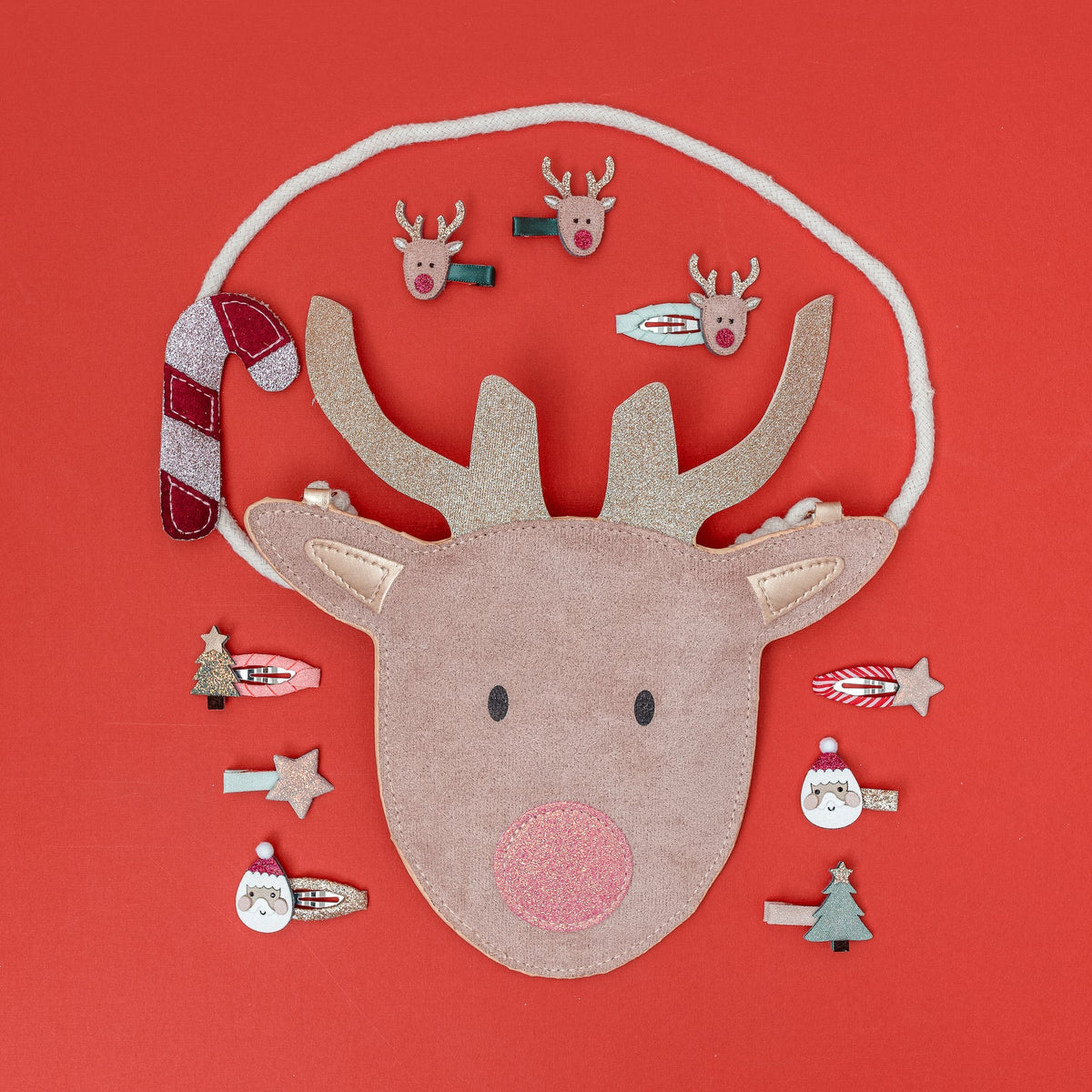 Felt reindeer head with accessories on a red background