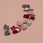 Set of colorful hair bows with decorative elements on a beige background