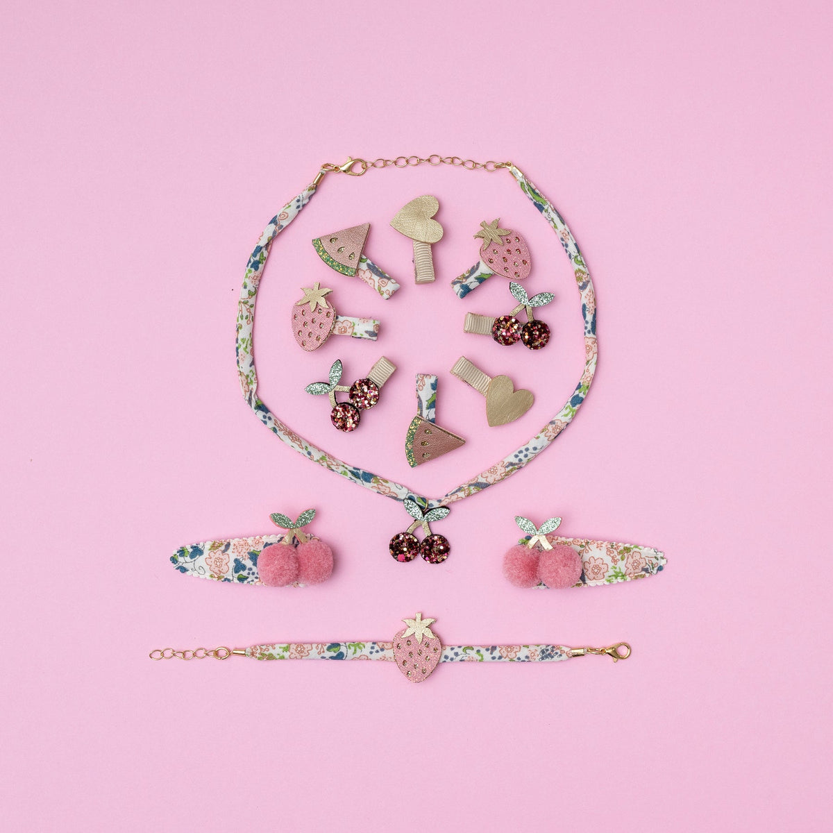 Collection of colorful hair clips on a pink background