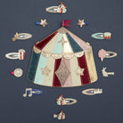 Decorative circus-themed hat with small accessories on a dark background