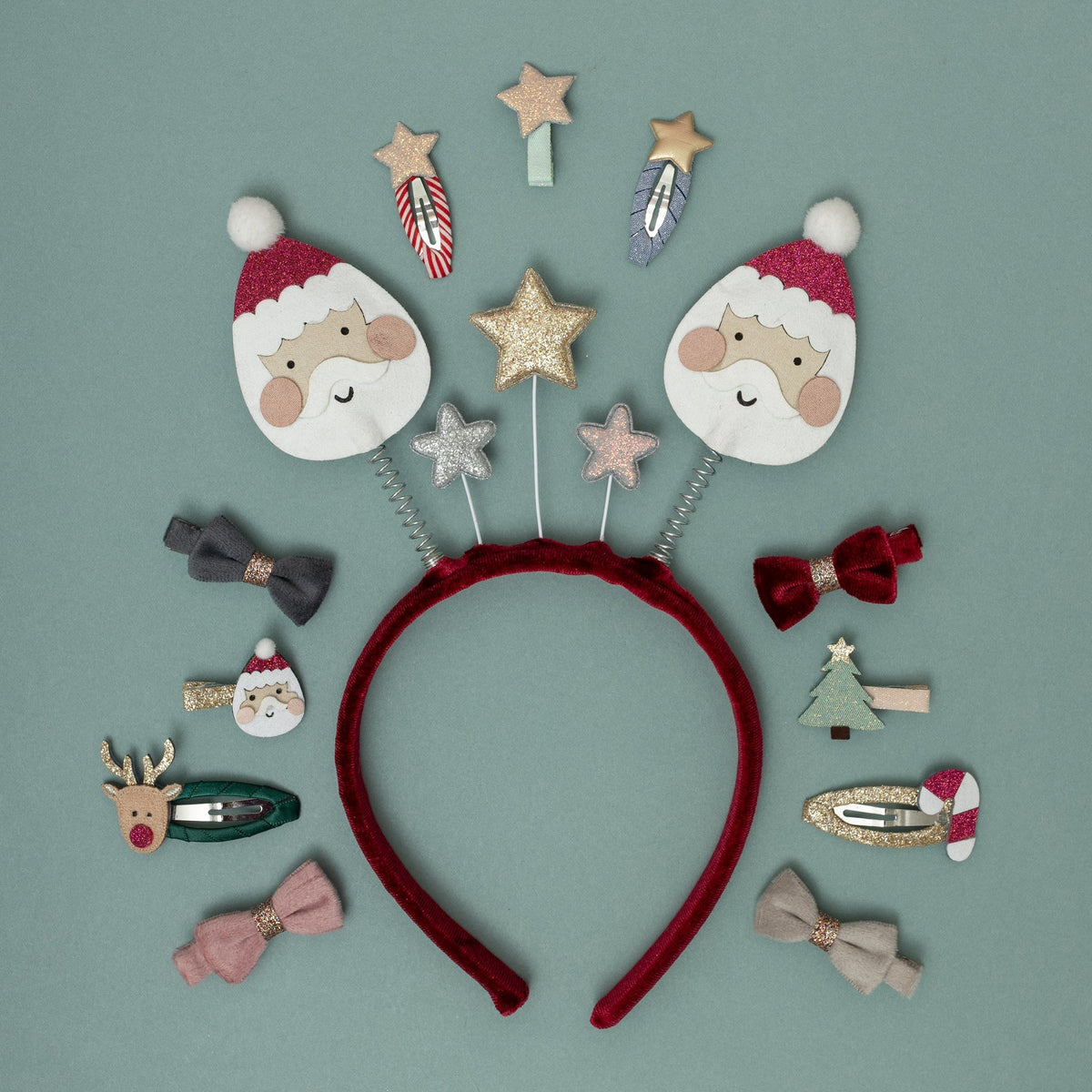 Red headband with Christmas-themed hair accessories on a green background