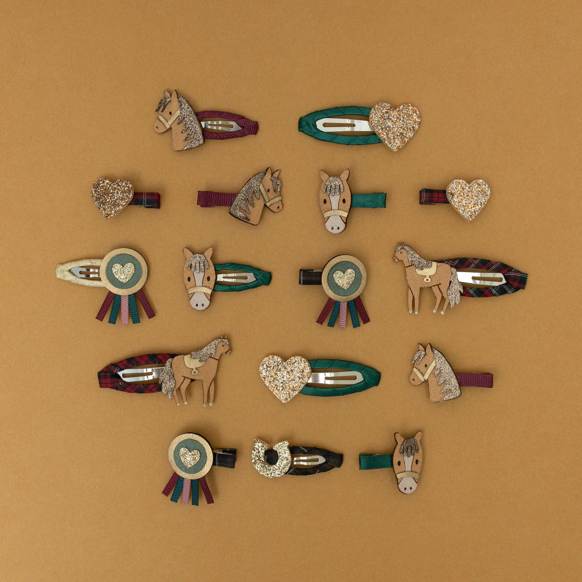 Collection of horse-themed hair clips on a brown background