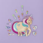 Unicorn-themed hair accessories on a purple background