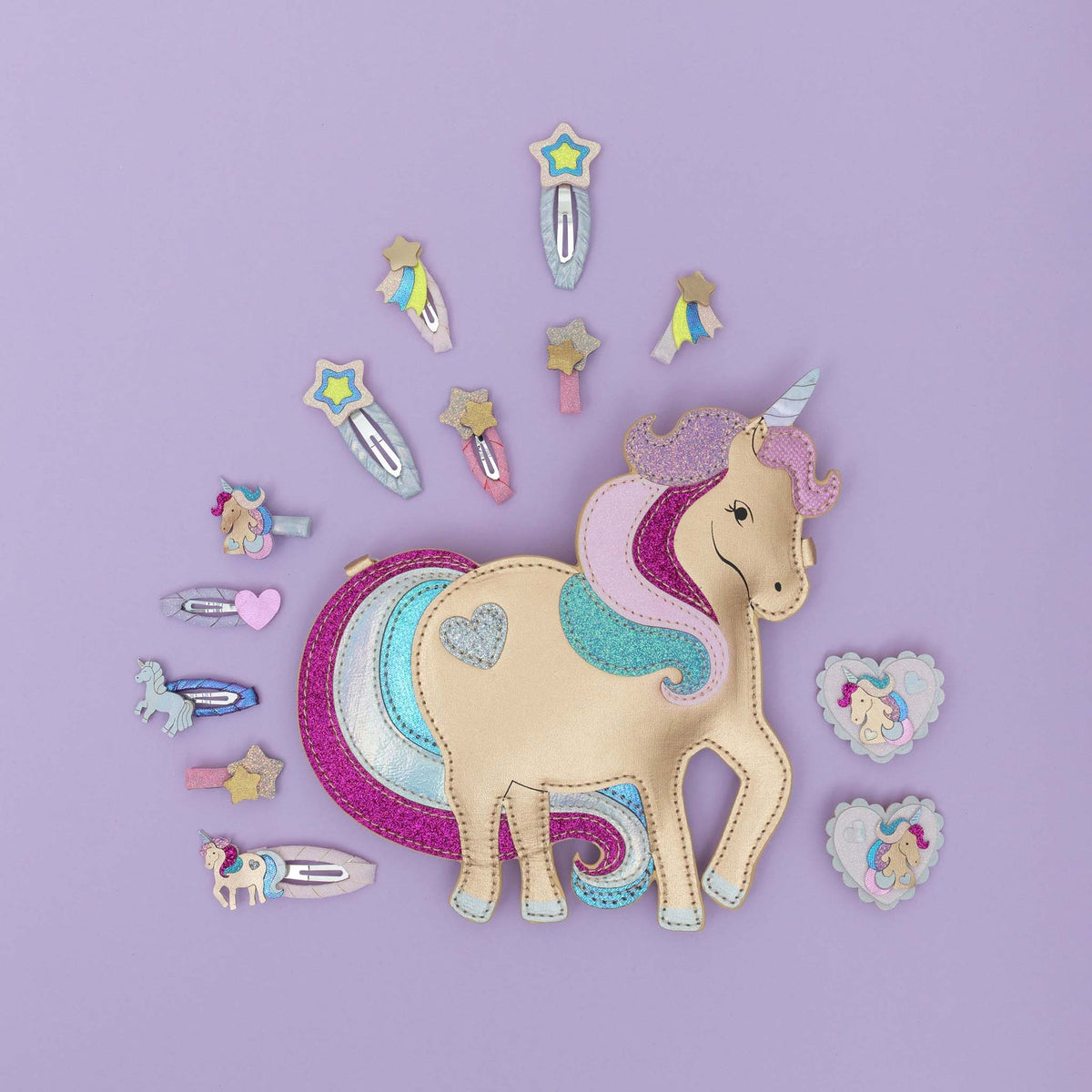 Unicorn-themed hair accessories on a purple background