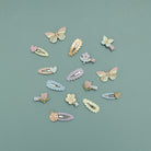 Pastel-colored hair clips arranged on a light blue background