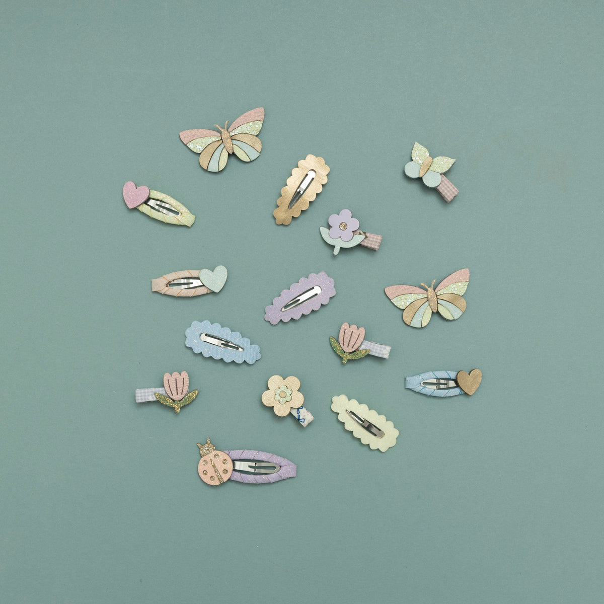 Pastel-colored hair clips arranged on a light blue background