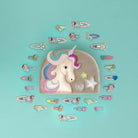 Unicorn-themed hair accessories on a teal background