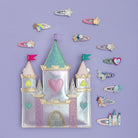 Decorative castle with colorful hair clips on a purple background