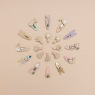 Various decorative hair clips arranged in a circular pattern on a beige background