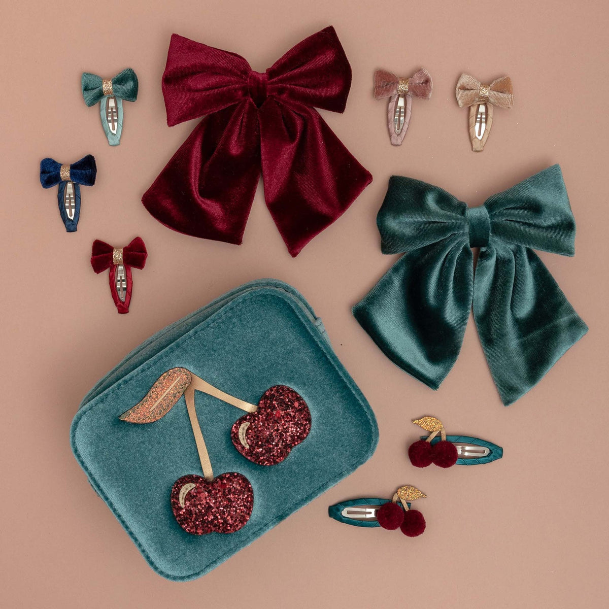 Collection of decorative hair bows and accessories on a beige background