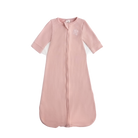 Pink baby sleeping bag with a white label on a white background