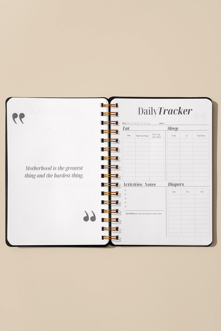 Open daily tracker notebook on a beige background