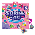 Ooly Cute Crew Shrink-Its! DIY Shrink Art Kit in pink packaging, shown with several colorful shrink-wrapped craft charms attached to cords on a white background.
