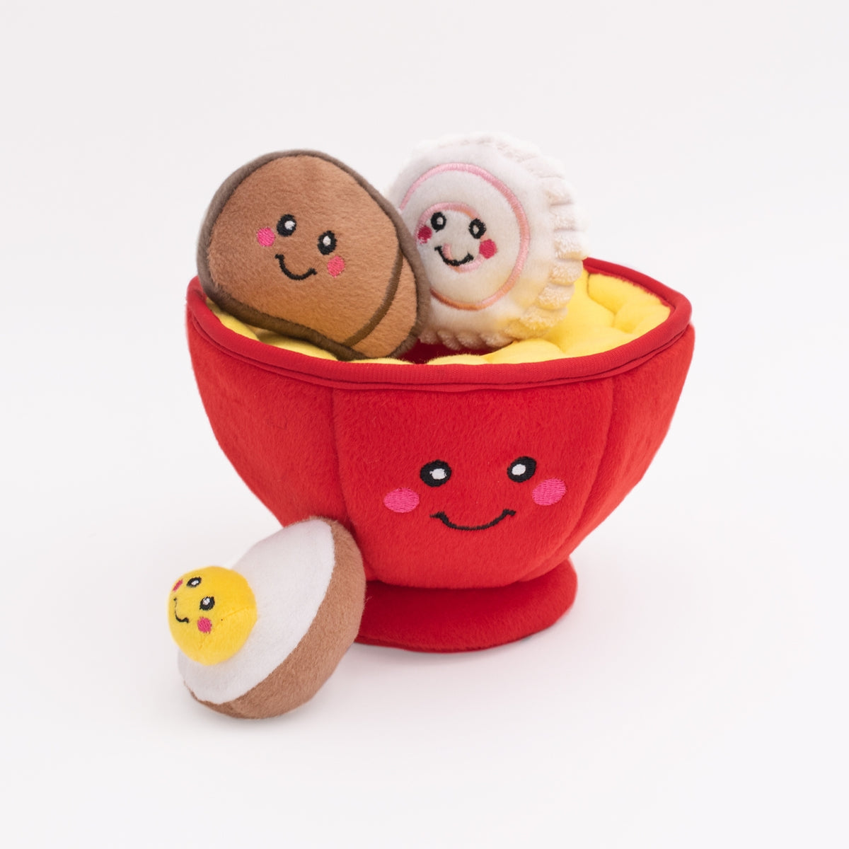 Plush toy set with a red bowl and smiling food items on a white background