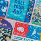 Collection of educational children's books and sticker sets on a clear background