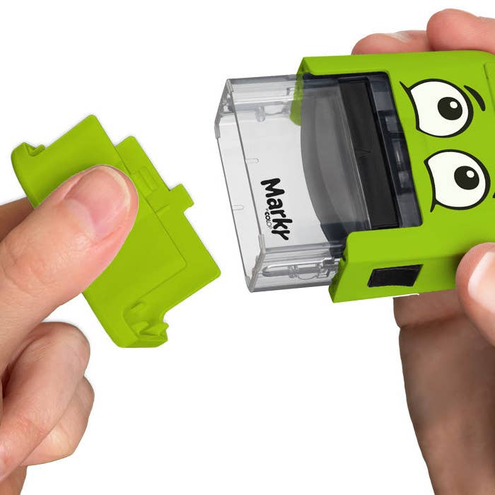 Green Markr branding tool held by a person with a white background