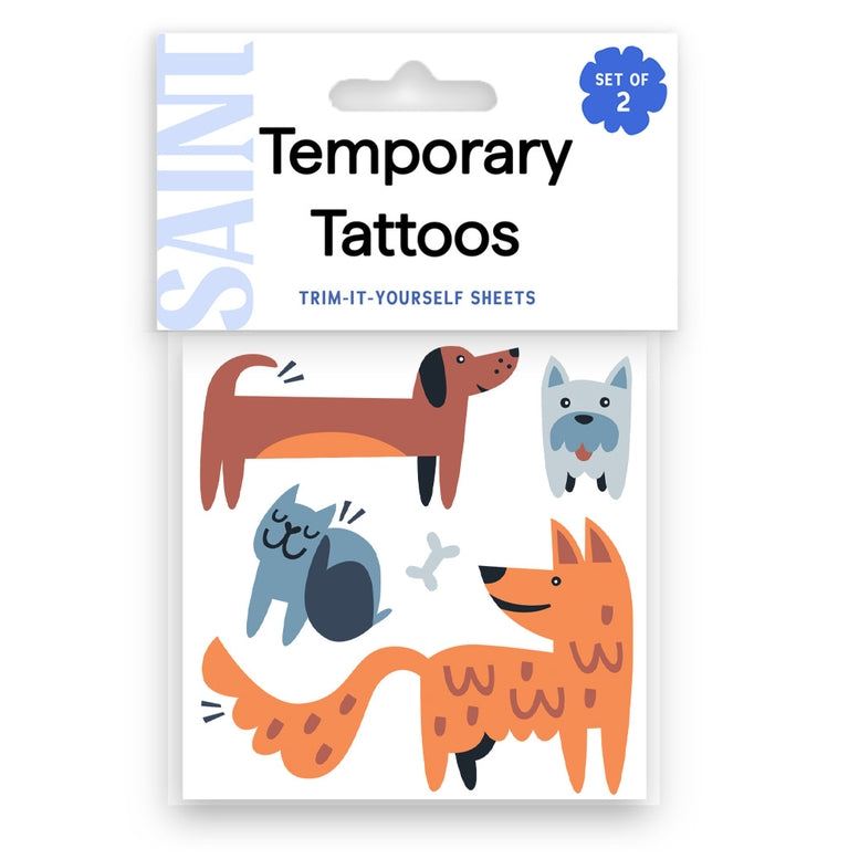 Saint brand temporary tattoo sheets featuring cute pet illustrations including a dachshund, cat, dog, and fox in orange, brown, blue, and gray colors.
