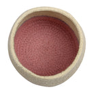 Round container with red interior and beige exterior on a white background