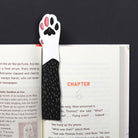 Bookmark with paw design on an open book