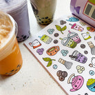 Colorful bubble tea stickers on a white surface with bubble tea cups.