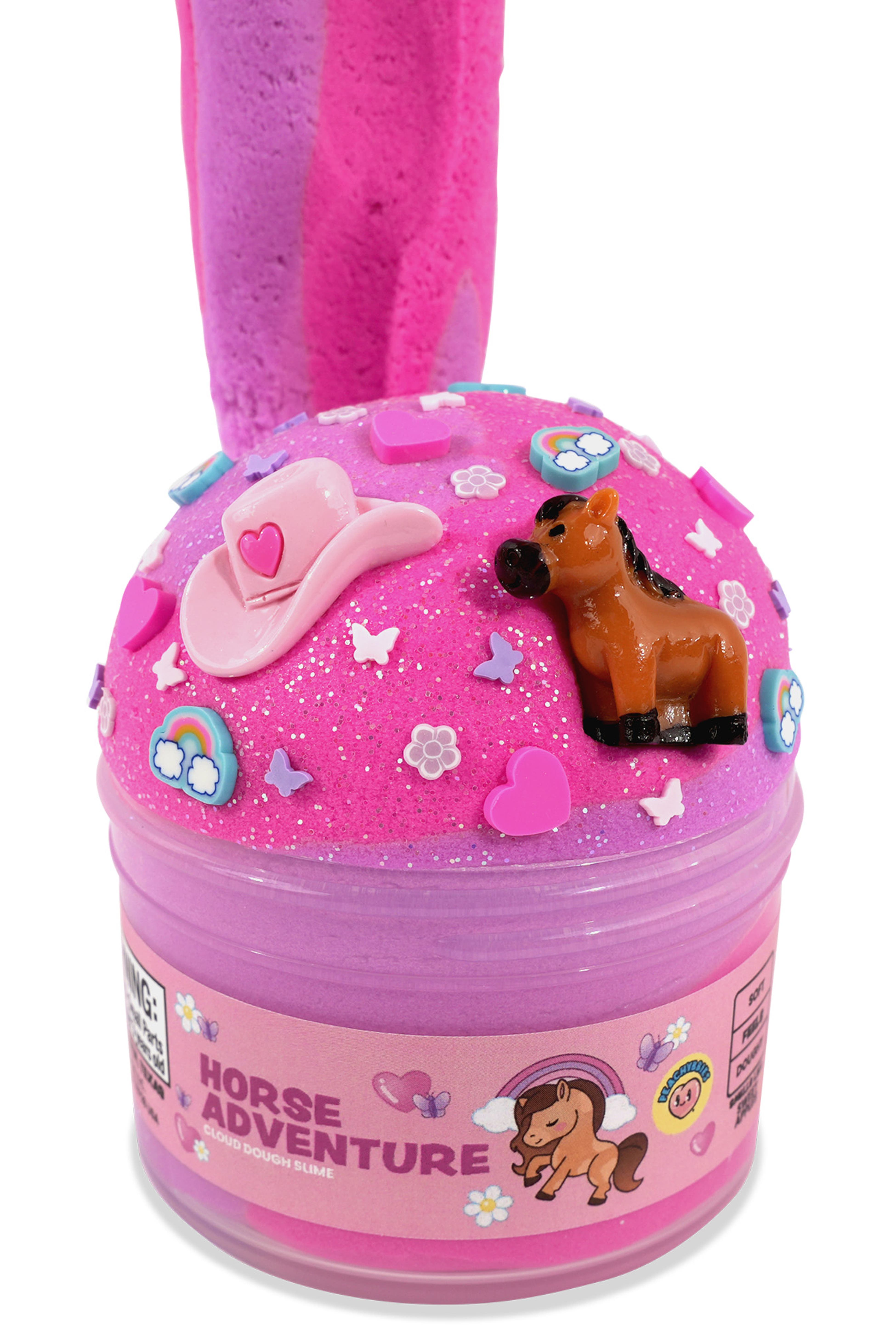 A pink slime toy container labeled 'HORSE ADVENTURE' with a small brown horse figure and decorative cowboy hat, stars, and flowers on top, shown on a white background.