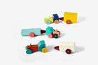 Set of colorful wooden toy trucks on a white background