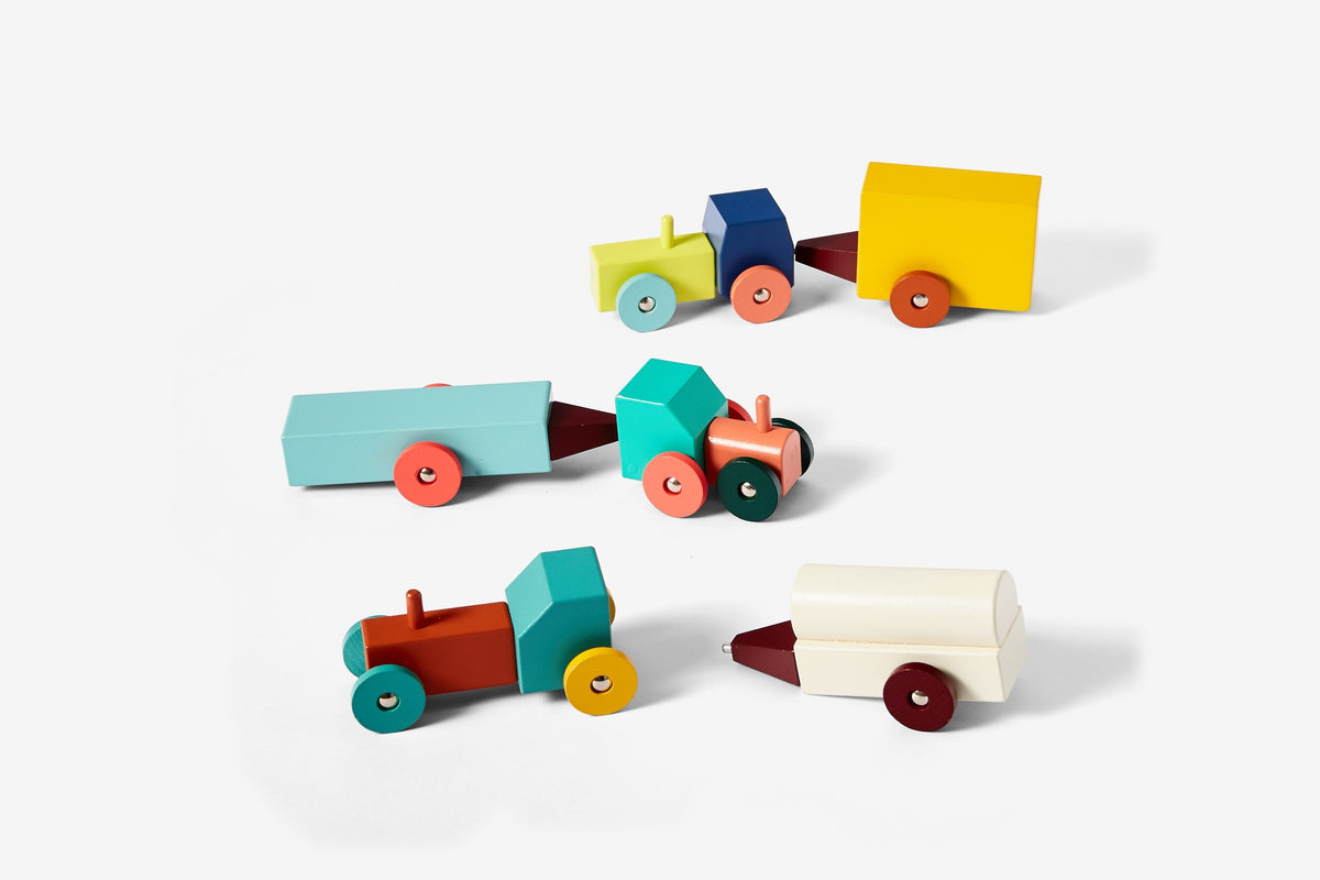 Set of colorful wooden toy trucks on a white background