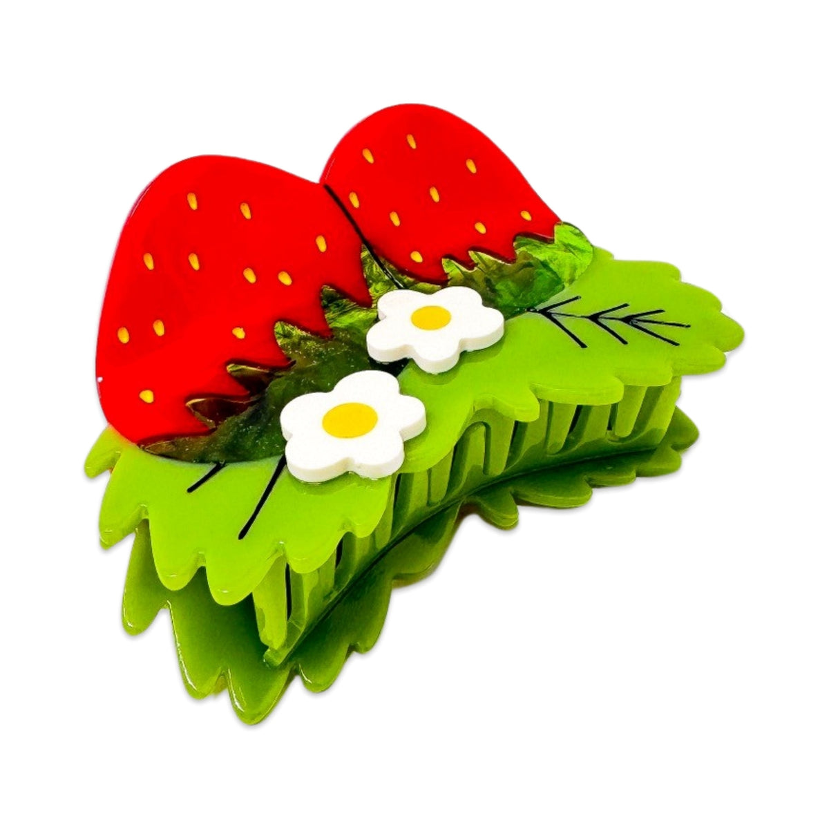 Hair clip designed like a strawberry with green leaves and white flowers on a white background