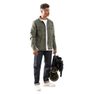 Man holding a black scooter with yellow wheels on a white background