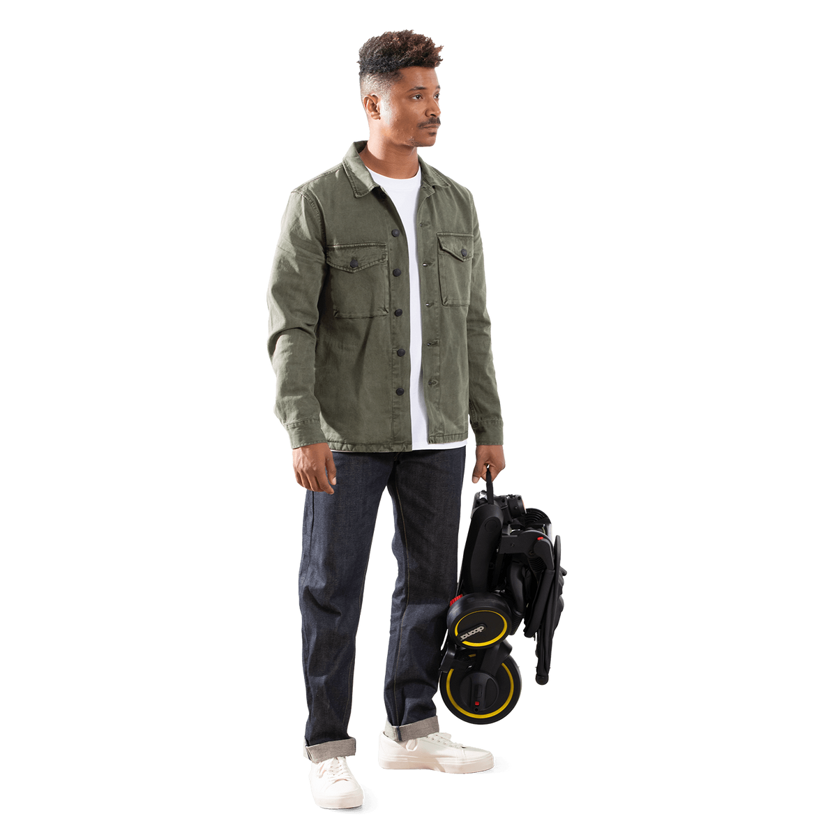 Man holding a black scooter with yellow wheels on a white background