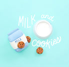 A cute flat-lay product photo of a miniature milk carton and a small open milk cup, both decorated with smiling chocolate chip cookies, on a light blue background with white hand-drawn text reading 'MILK and COOKIES'.