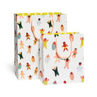 Two colorful gift bags with cartoon character pattern on a white background