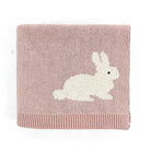 A square knitted baby blanket in dusty pink with a white rabbit motif and a ribbed hem, shown on a plain white background.