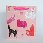Packaging with colorful cat illustrations on a pink background