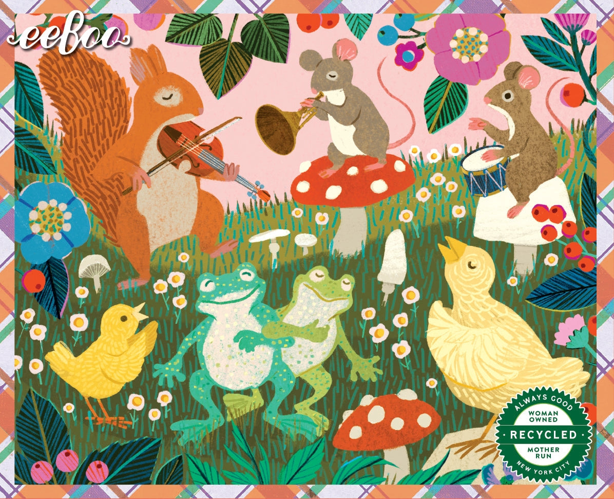 A colorful illustrated textile pattern featuring woodland animals: a squirrel playing violin, a mouse on a red mushroom playing trumpet, another mouse playing drum, two frogs dancing, a yellow chick, and a white duckling, with flowers, leaves, and mushrooms on a pink background. The brand name 'jeeboo' appears in the upper left, and a 'Made with recycled wool by Handmade Hooky' badge appears in the lower right.