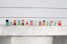 Row of small figurines on a white surface with a light gray background
