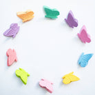 Colorful butterfly-shaped clips on a white background